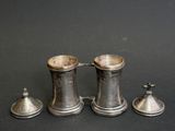 three silverplated pewwares on a black background
