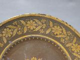 a brown plate with a yellow flower design on it