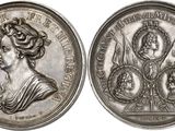 a close up of a silver coin with a woman on it