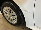 a close up of a white car with a measuring tape on the side of it