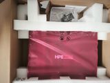 a pink bag sitting inside of a box on top of a table