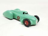a green toy car that is sitting on a white surface