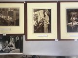 trois tableaux encadrés accrochés au mur au-dessus d'un poêle