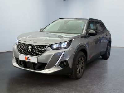 the front view of a silver suv parked in a showroom