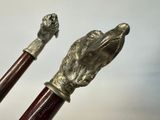 two walking sticks with a metal handle and a hand on one