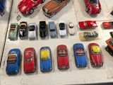 a lot of toy cars on display on a table