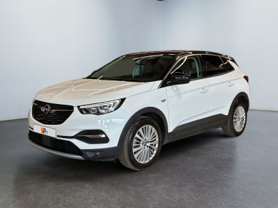 a white car is parked in a white room with a black floor