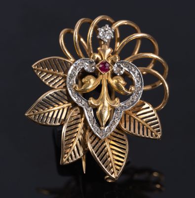 a close up of a gold and diamond flower ring on a black surface