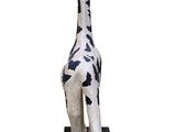a statue of a giraffe that is standing on a black base