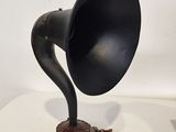 a black and silver gramphone on a table next to a lamp