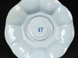 a white plate with a number on it on a black surface