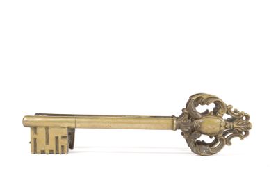 a gold key that is sitting on top of a table