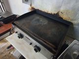 a stove with a pan on top of it in a kitchen