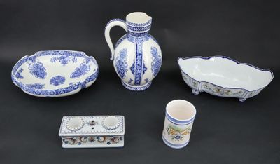 four pieces of blue and white pottery on a black background