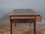 a small desk with a drawer on top of it