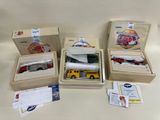 four boxes with different types of toy vehicles in them
