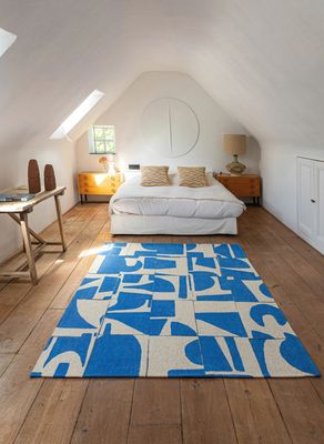 un tapis bleu et blanc au milieu d'une pièce