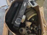a cardboard box full of old cameras and other electronics
