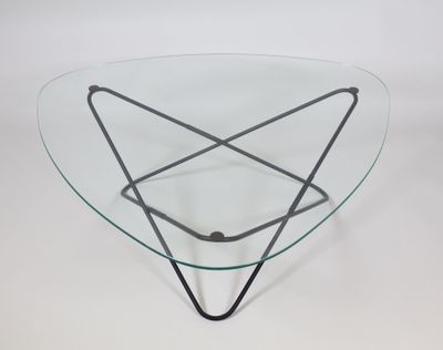 a glass coffee table with a metal base and a triangular glass top