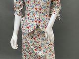 an image of a mannequin wearing a floral dress and jacket
