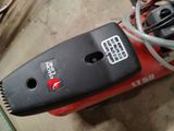 a red and black vacuum that is sitting on the floor