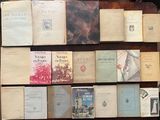 several old books are stacked on top of each other on a table