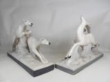 pair of white ceramic sculptures of a polar bear and a polar bear