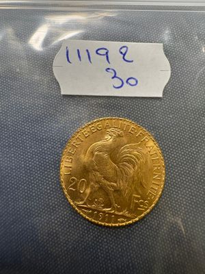 a close up of a gold coin with a label on it
