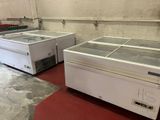 two refrigerated freezers sitting in a room
