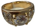 an image of a gold ring with three diamonds on it