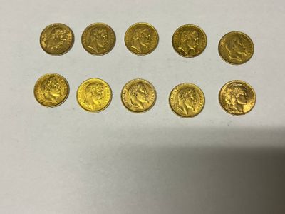 a bunch of gold coins sitting on top of a white table