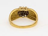 a close up of a gold ring with black and white diamonds