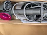 a box with a bunch of different types of hair dryers in it