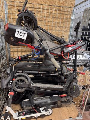 a pile of scooters in a cage with a number plate on it