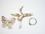 two pieces of jewelry on a white surface