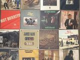 a lot of different album covers on a table