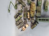 a lot of toy army vehicles that are on the table