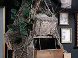 a wooden box with a net hanging from it ' s side