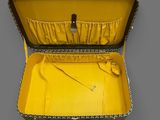 an open yellow suitcase sitting on top of a gray surface