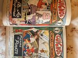 two comics sitting on a bed next to each other
