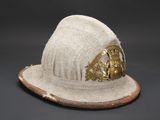 an old white hat with a gold buckle on top of it
