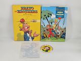 two children ' s books and a sticker on a white surface