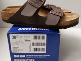 a box with a pair of sandals on top of it