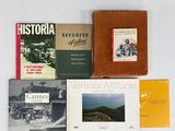plusieurs livres sont posés sur une surface blanche avec un fond blanc