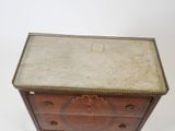 an antique wooden chest of drawers with marble top and brass trimming