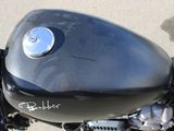 a close up of a black motorcycle parked on the side of the road