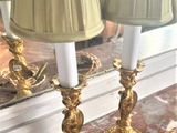 two lamps that are sitting on a table in front of a mirror