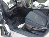 the interior of a car with the door open and the driver ' s seat down