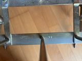 a close up of a metal object on a wooden floor