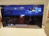 a flat screen tv sitting on a bed in a room